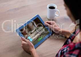 Woman with coffee and tablet in login screen