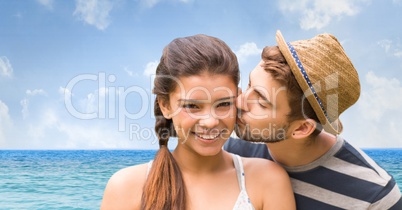 Loving man kissing woman on at beach