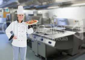 Chef with pizza in the restaurants kitchen