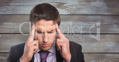 Thoughtful businessman against  wooden background