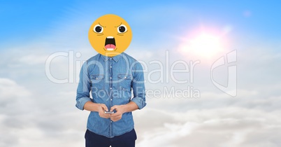 Digital composite image of man using phone face covered with emoji against sky