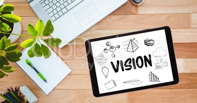 High angle view of vision text in tablet computer by laptop on table