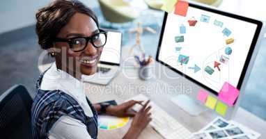 Happy businesswoman using computer with various graphics