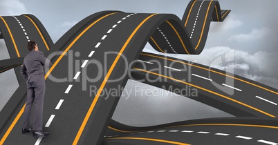 Digital composite image of confused executive standing on wavy road leading towards sky