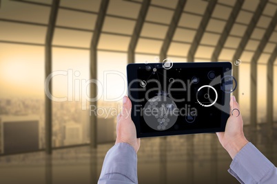 Business person holding tablet PC with IOT graphics in office