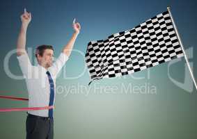 Business man at finish line against blue green background and checkered flag