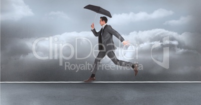 Digital composite image of businessman with umbrella running on rope over sea