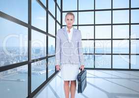 Business woman in front of the window of the office. City behind