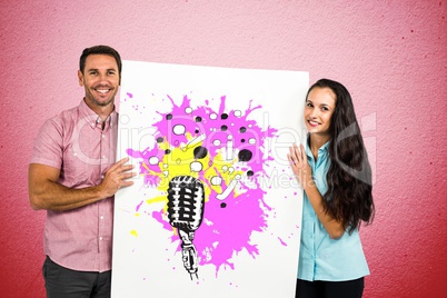 Portrait of smiling couple holding billboard with various icons against pink wall