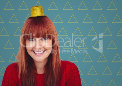 Woman in party hat against blue background with yellow triangle pattern