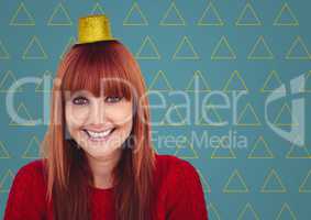 Woman in party hat against blue background with yellow triangle pattern