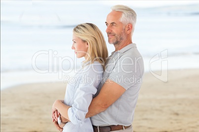 Side view of affectionate senior couple standing at beach