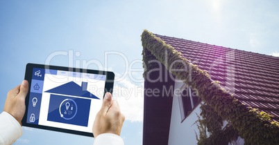 Cropped image of person using smart home app with house in background