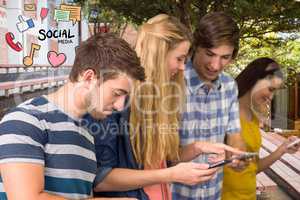 Happy friends using social media on smart phones