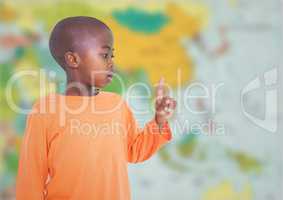 Boy pointing against blurry map