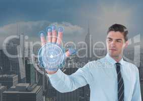 Business man with hand scan in front of the city