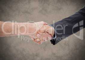 Handshake against brown grunge background