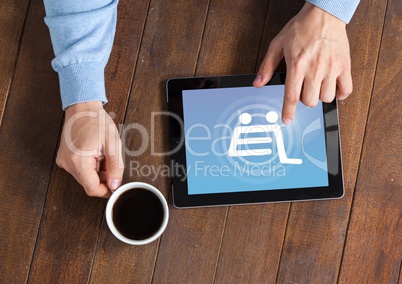 Man using Tablet with Shopping trolley icon and coffee