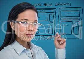 Business woman with pen and website mock up against blue background