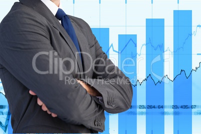 Midsection of businessman standing with graphs in background