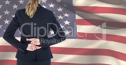 Midsection of female professional crossing fingers against American flag