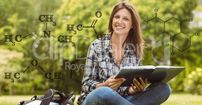 Female student holding book with formulas in foreground