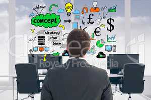 Rear view of businessman looking at icons in office