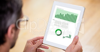 Cropped image of businessman reviewing graphs on tablet PC