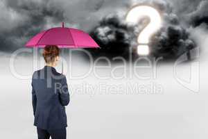 Digital composite image of businesswoman with umbrella looking at question mark in sky