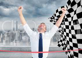 Business man at finish line against skyline and checkered flag