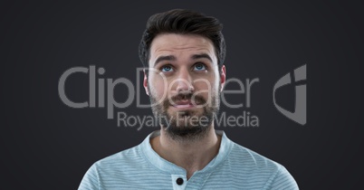 Man looking up against dark grey background