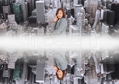 up side down city.mirror effect with white flares in the middle of two cities and woman looking down