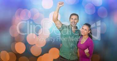 Happy couple celebrating success over bokeh