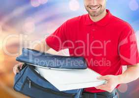 Happy deliveryman with the delivery bag and pizza boxes. Lights background