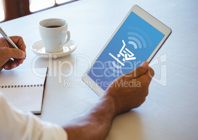 Person using Tablet with Shopping trolley icon and coffee