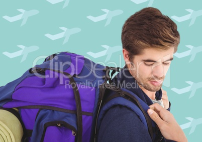 Man with backpack against aqua aeroplane pattern