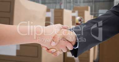 Cropped image of business people doing handshake in warehouse