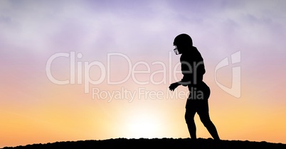 Silhouette sportsperson walking on field against sky during sunset