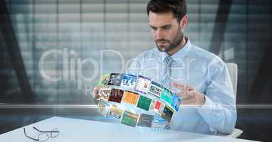 Businessman looking at panels spinning on desk