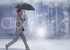 Businessman walking with umbrella in city