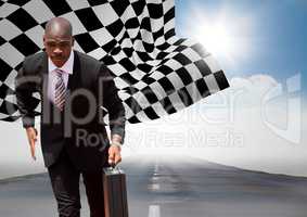 Business man running with briefcase on road against sky with sun and checkered flag