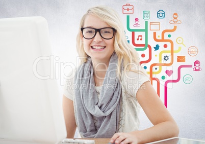 Woman at computer against colourful business graphics and white wall