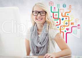 Woman at computer against colourful business graphics and white wall