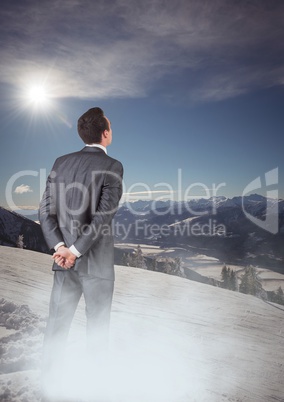 Business man with mist standing looking at mountains