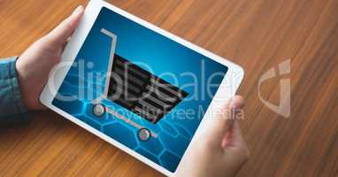 Shopping cart on tablet PC's screen held by woman