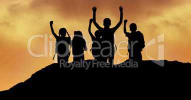 Silhouette children with arms raised on hill against sky during sunset
