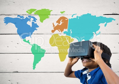 Boy with VR headset next to Colorful Map with paint splatters on wood background