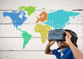 Boy with VR headset next to Colorful Map with paint splatters on wood background