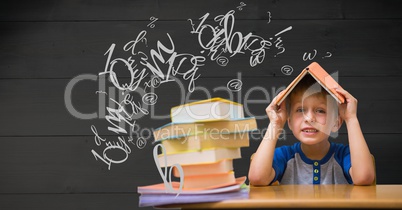Schoolboy holding book over head with letters flying in background