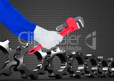 hand with tool with metal and cogs background